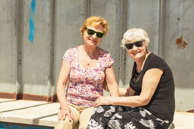 Two elderly women are happy to meet each other