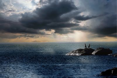 Scenic view of sea against sky at sunset