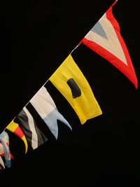 Close-up of flags flag against black background