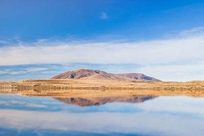 Scenic view of arid landscape against sky