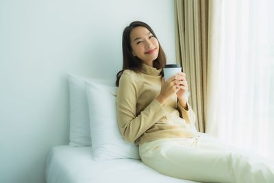 Young woman sitting on mobile phone