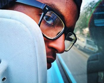 Close-up portrait of young man wearing sunglasses