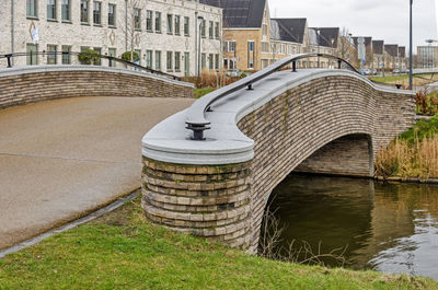 Bridge with sculpural brick railing, across a canal in a new suburb