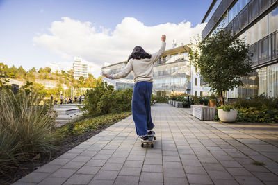 Girl skateboarding in residential area