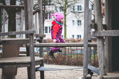 Side view of girl playing in play