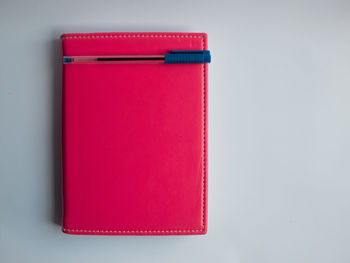 Directly above shot of red container on table against white background