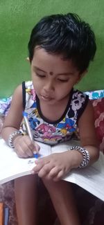 Close-up of girl looking away while sitting on seat