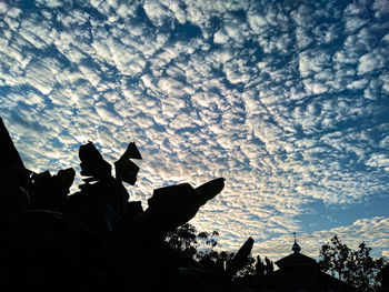 Low angle view of silhouette men against sky during sunset