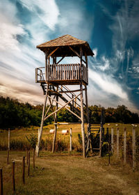 Built structure on field against sky