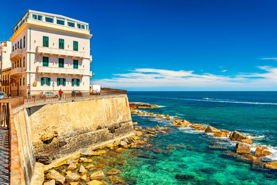 Scenic view of sea against clear blue sky