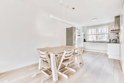 Empty chairs on hardwood floor at home