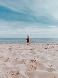 Full length of man on beach against sky