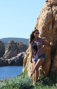 Full length of woman standing against rock formation