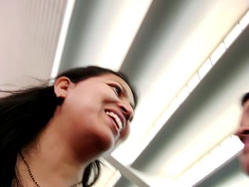 Close-up of smiling young woman at home