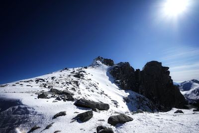 Scenic view of snowcapped mountains against clear blue sky