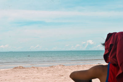 Man on beach against sky