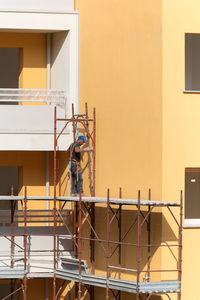 Man working at construction site against building