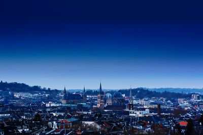 High angle shot of townscape against blue sky