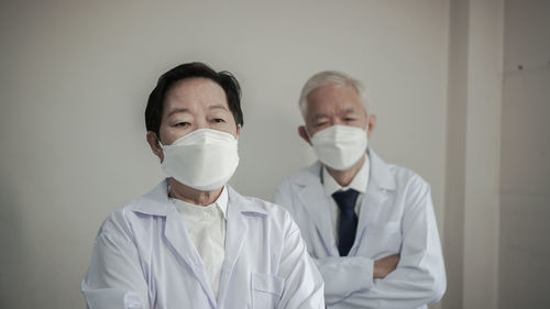 Portrait of friends standing in front of house