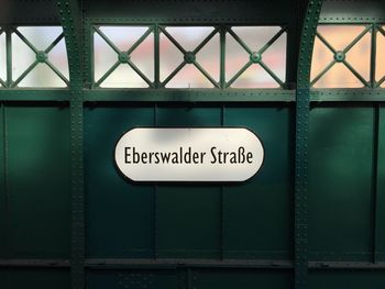 Eberswalder strabe sign on green metallic wall at railroad station