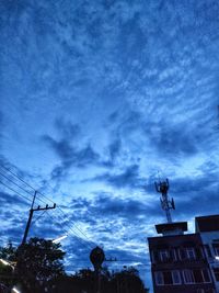 Low angle view of silhouette building against sky
