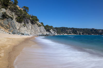 Scenic view of beach against clear sky