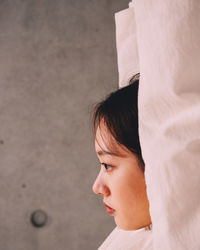 Side view of young woman exercising at home