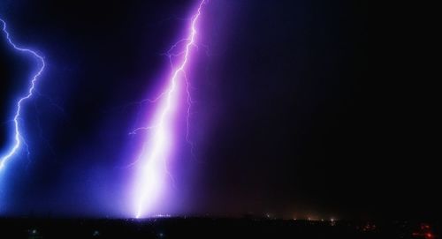 Low angle view of lightning against sky at night