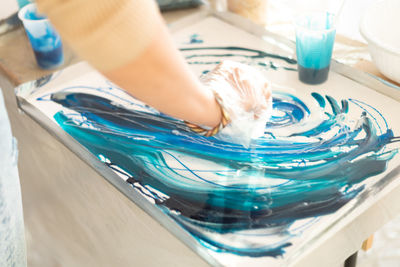 Cropped hand of woman washing ice cream