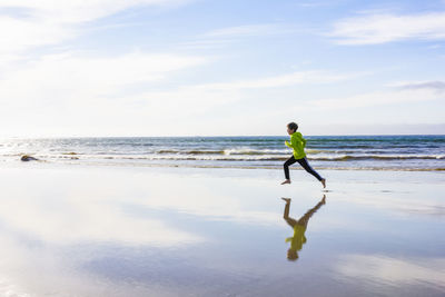 Boy running on a beach