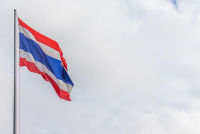 Low angle view of flag against sky