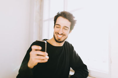 Close-up of young man using mobile phone