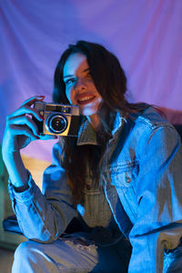 Young woman photographing with camera