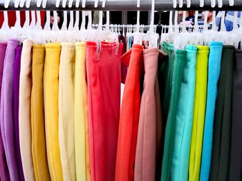 Close-up of multi colored skirts hanging at clothing store