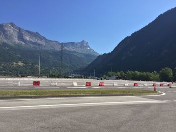 Road by mountain against clear sky