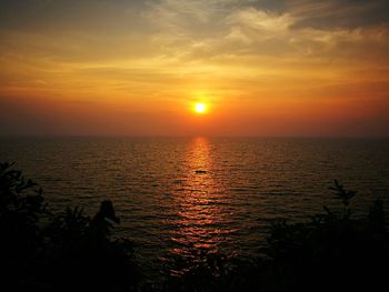 Scenic view of sea against romantic sky at sunset