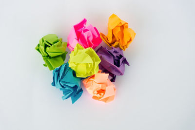 High angle view of multi colored pencils on white background