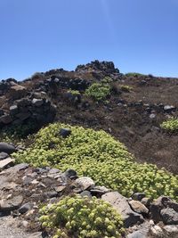 Scenic view of rocks against clear blue sky