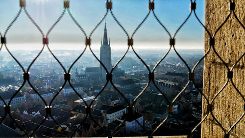 Cityscape seen through chainlink fence