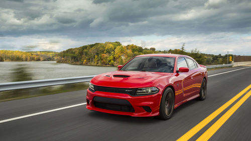 Red car on road against sky