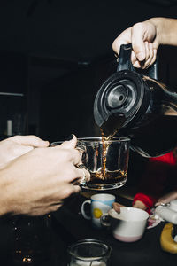 Young businessman pouring coffee for coworkers in office