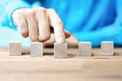 Midsection of person with toy on table