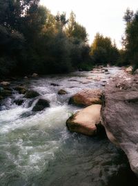 Scenic view of river flowing through rocks