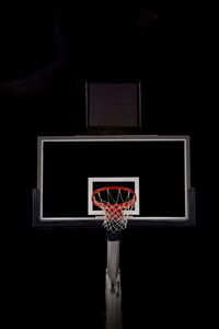 Low angle view of basketball hoop at night