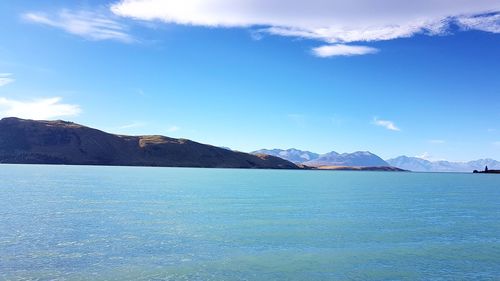 Scenic view of mountains against blue sky