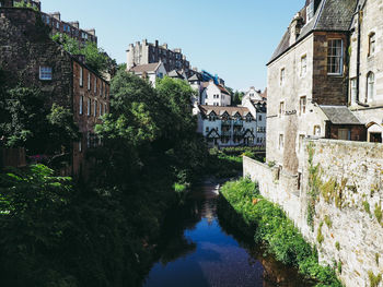 Canal amidst buildings against sky