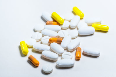 High angle view of multi colored pencils on white background