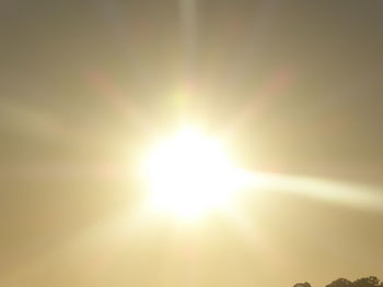 Low angle view of sun in sky