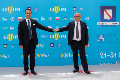 Full length of a man standing against blue wall