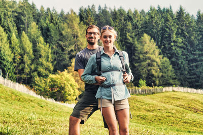 Portrait of smiling young woman standing on land